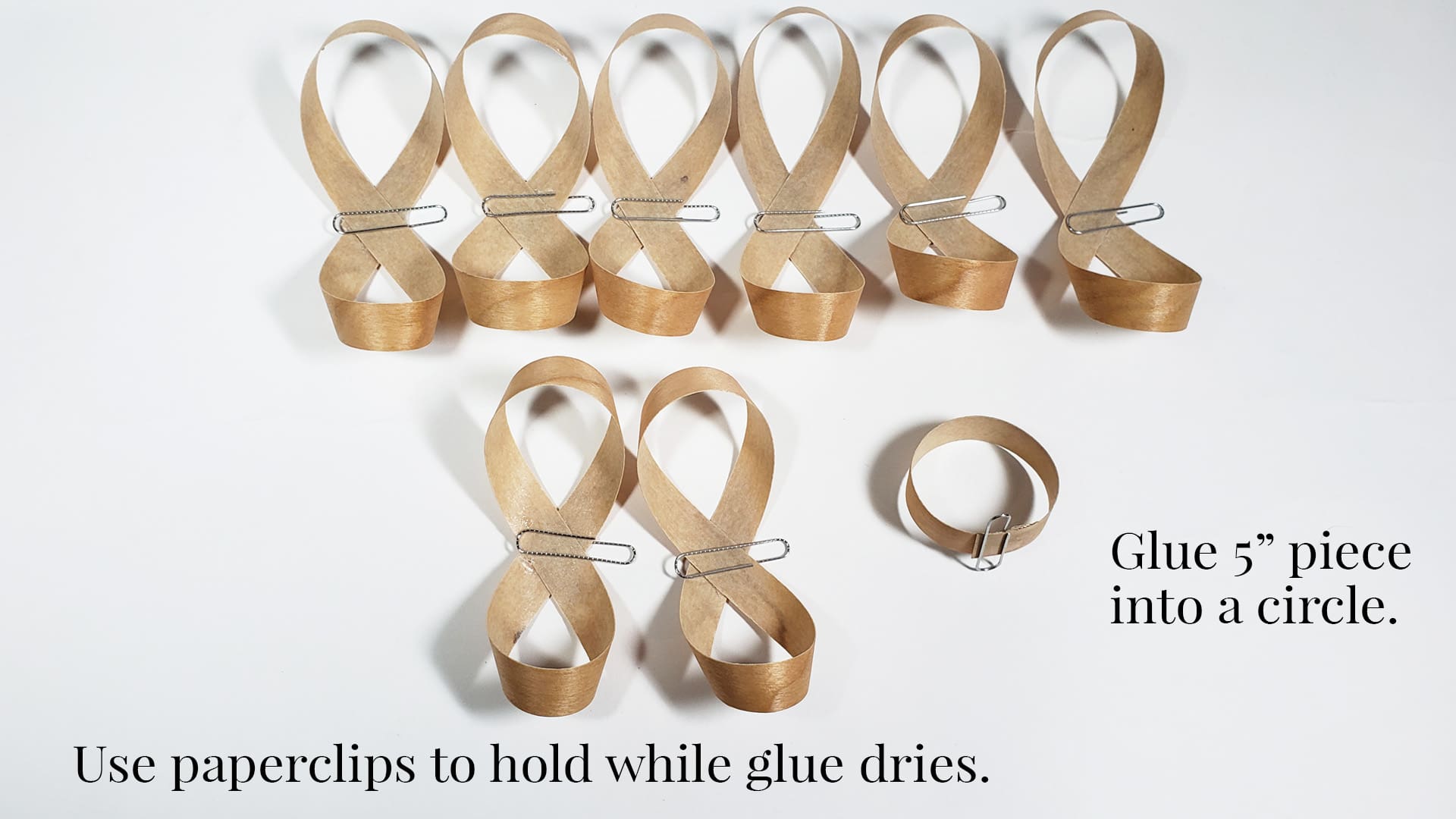 Use paperclips to hold while wood and glue are drying